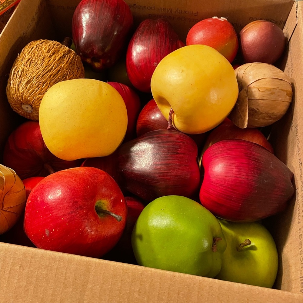 Box of mixed artificial apples.